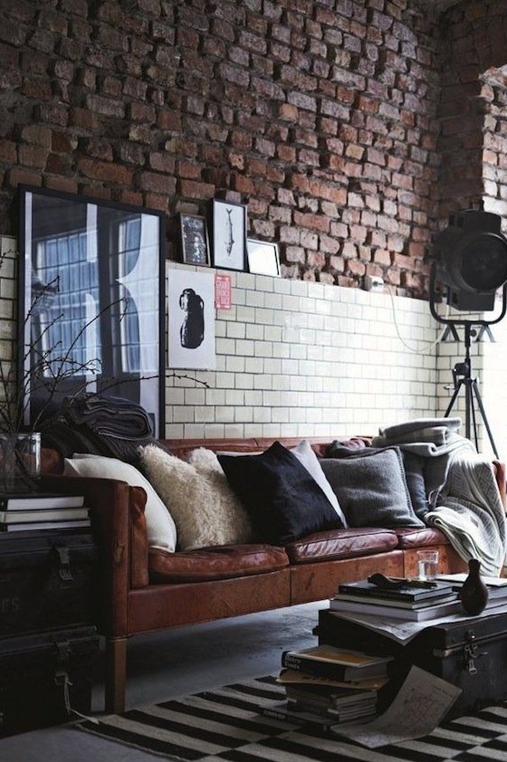 an industrial space with a brown leather Stockholm sofa that brings style and a touch of chic and cool color