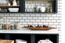 black open cabinets, a white subway tile backsplash and white countertops, stained shelves and beautiful tableware and dishes