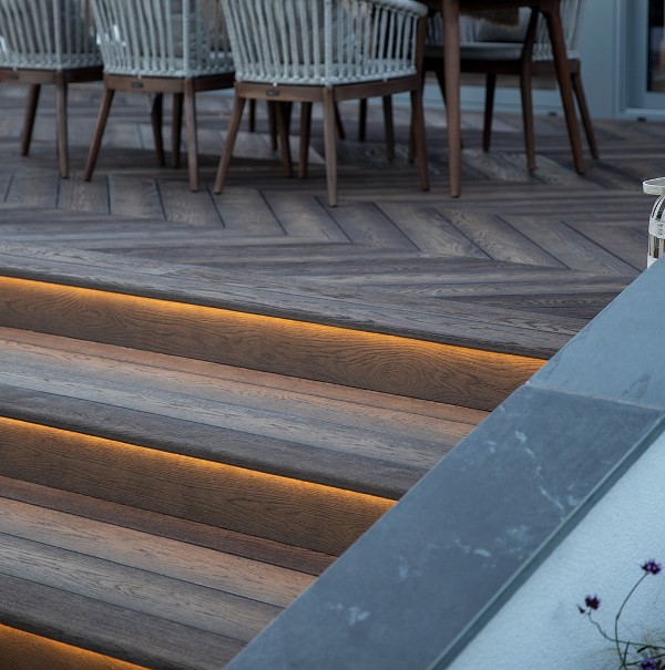 enhanced grain anique oak composite decking, stairs with built in lights create an elegant and stylish look of the terrace