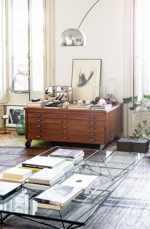 a stained low filing cabinet on casters is a console table in your living room that provides storage and that you can style