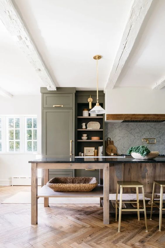 https://www.digsdigs.com/photos/2023/04/a-beautiful-farmhouse-kitchen-with-an-olive-green-cabinet-and-a-stained-kitchen-island-a-hood-pendant-lamps-and-gold-and-brass-knobs.jpg