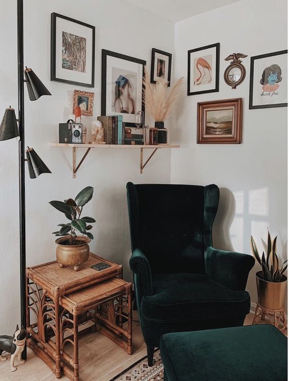 a chic boho nook with a green Strandmon chair and a matching ottoman, a shelf, a gallery wall and a couple of rattan side tables