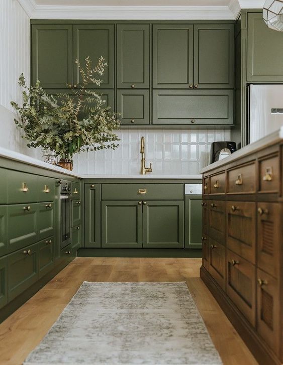 مطابخ باللون الاخضر الزيتي A-chic-olive-green-farmhouse-kitchen-with-shaker-cabinets-a-white-tile-backsplash-a-dark-stained-kitchen-island-and-a-printed-rug