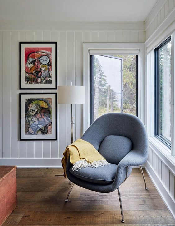 a cool nook by the window with bold artwork and a grey Wumb chair with a bold blanket is cool