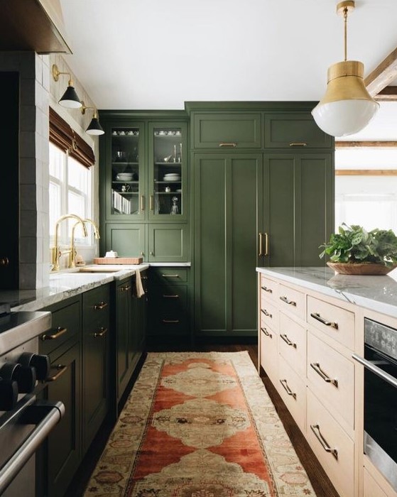 مطابخ باللون الاخضر الزيتي A-dark-green-kitchen-a-light-colored-wood-kitchen-island-white-stone-countertops-and-gold-touches-for-a-mid-century-modern-feel