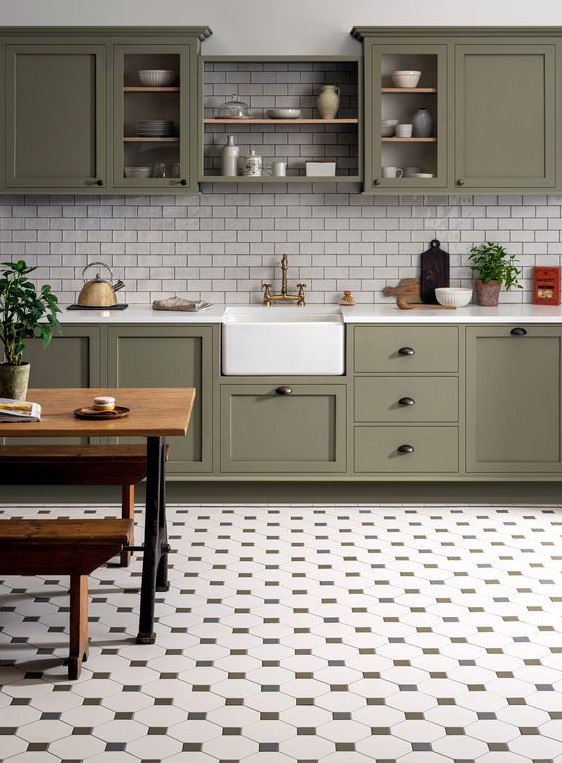 مطابخ باللون الاخضر الزيتي A-stylish-farmhouse-olive-green-kitchen-with-white-subway-tiles-and-a-pretty-tile-floor-plus-a-rustic-dinign-set-is-wow