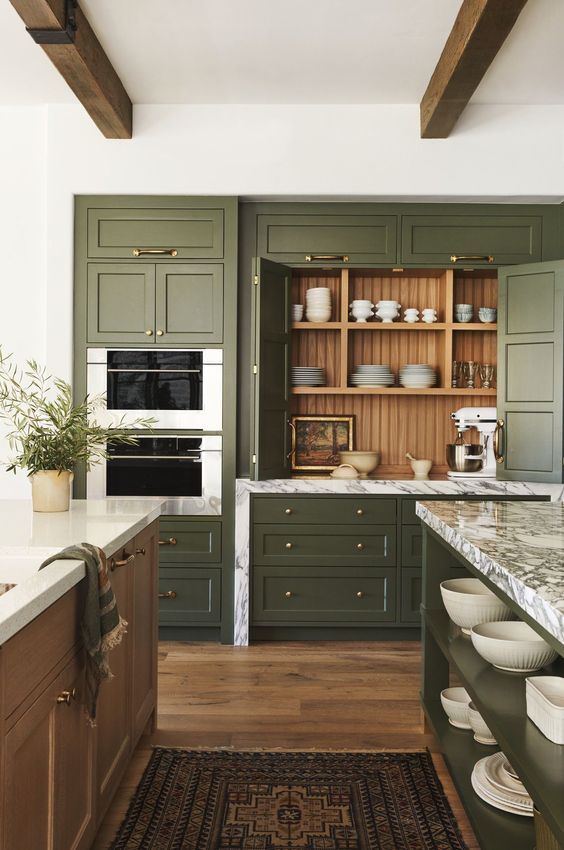 a vintage olive green kitchen with shaker cabinets, a stained kitchen island, white stone countertops and open shelves