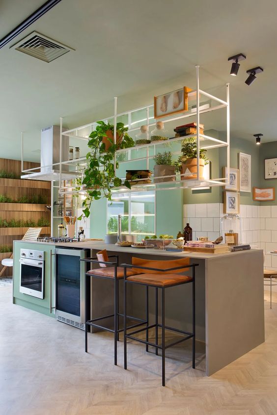 a bright modern kitchen with green walls, white square tiles, a kitchen island and a cabinet, a suspended shelf over it