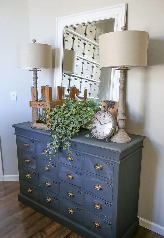 a vintage file cabinet painted in graphite grey as a chic and unusual entryway console fo a rustic or vintage space