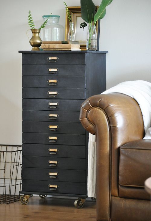 a beautiful chalkboard file cabinet on casters is a stylish storage unit that can be also styled with some greenery and art on top