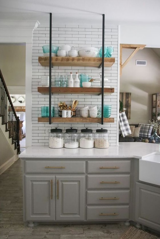 a grey farmhouse kitchen, a white tile backsplash and suspended shelves, white countertops for a rustic space