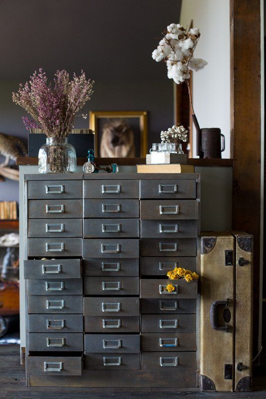 a grey card cabinet styled with dried blooms is a lovely rustic and vintage decor and storage piece to try