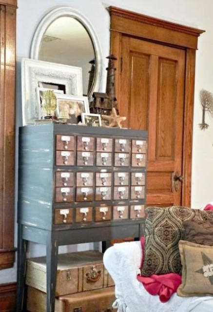 a renovated card cabinet on tall legs with various decor is a lovely soluton for a vintage or rustic entryway
