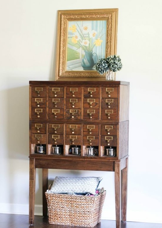 a rich-stained card cabinet on tall legs and with some lovely decor will be a nice idea for many living rooms and home offices