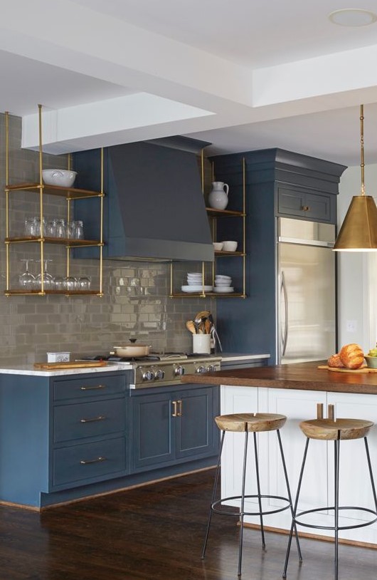 https://www.digsdigs.com/photos/2023/05/20-an-elegant-blue-kitchen-with-a-glossy-grey-tile-backsplash-suspended-brass-shelves-brass-pendant-lamps-and-stools.jpg