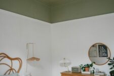 23 an eclectic bedroom with an olive green ceiling, a bed with a woven headboard, a stained dresser, pendant petal lamps and a round mirror