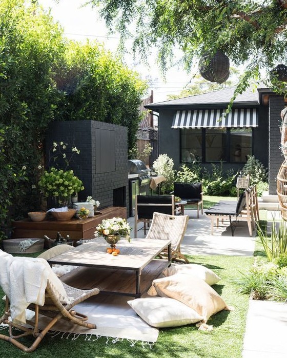 a small backyard that comprises and living room zone and a fireplace zone done in different styles and contrasting colors a small backyard that comprises and living room zone and a fireplace zone done in different styles and contrasting colors