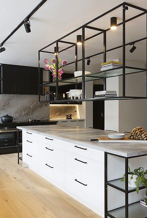 https://www.digsdigs.com/photos/2023/05/28-a-contemporary-kitchen-with-black-cabinets-a-white-kitchen-island-suspended-shelves-over-the-island-and-built-in-lights.jpg