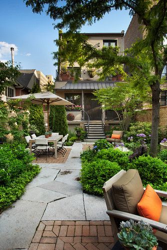 a small garden with a lot of greenery and trees, with stone tiles and brick paths, modern garden furniture is cool a small garden with a lot of greenery and trees, with stone tiles and brick paths, modern garden furniture is cool