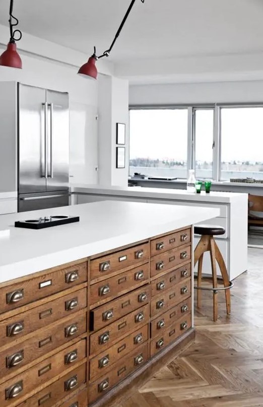 a large antique file cabinet got a thick white counter and became an amazing kitchen island