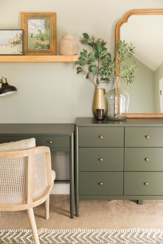 a pretty olive green dresser and a matching desk with gold knobs beautifully blend with a farmhouse space and add a delicate touch of color