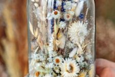a beautiful and a bit messy flower dome with dried neutral blooms, grasses and bold lavender is a cool summer decoration