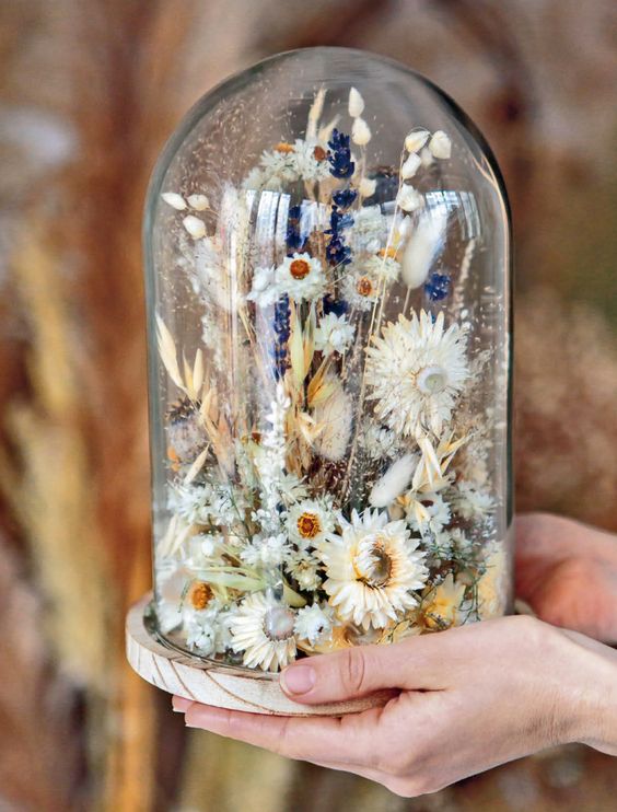 a beautiful and a bit messy flower dome with dried neutral blooms, grasses and bold lavender is a cool summer decoration