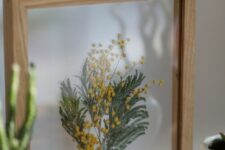 a bit of pressed leaves and berries in a light-stained frame will be a nice summer or fall decoration for your space