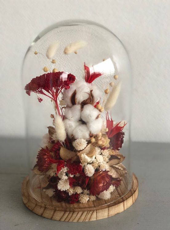 a bold fall flower dome with cotton, burgundy blooms and white dried ones and berries and grasses is very cool