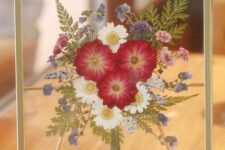 a bright pressed flower bouquet in a gilded frame is a lovely decoration that will add color, it’s a fresh take on a usual arrangement