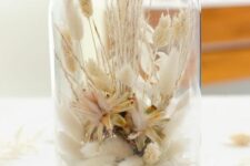 a cloche dried flower arrangement wiht dried neutral blooms, lots of herbs and leaves and some wheat is a very cool idea to try, it looks delicate