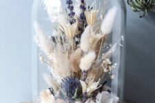 a cloche with lavender, thistles, white petals, bunny tail grasses and berries is a lovely boho home decor idea