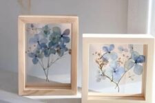 a duo of light-stained frames with blue pressed blooms is a cool decoration that will add a bit of color