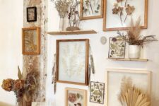 a gallery wall of pressed flowers and leaves in light-stained frames and grasses in vases is a cool and chic idea