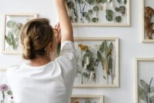 a gorgeous gallery wall with leaves, blooms and grasses in light-stained frames is a chic and cool idea for any relaxed space