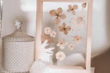 a light-stained frame with dried blooms and leaves is a beautiful home decoration for a boho or rustic space