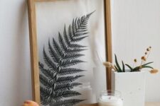 a single fern leaf in a light-stained frame is a beautiful and delicate artwork that is easy to DIY