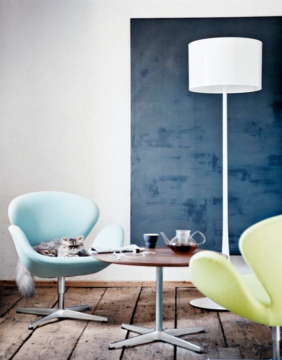 https://www.digsdigs.com/photos/2023/05/a-stylish-space-with-a-navy-accent-wall-a-light-blue-and-neon-yellow-Swan-chairs-a-coffee-table-and-a-floor-lamp-is-cool.jpg