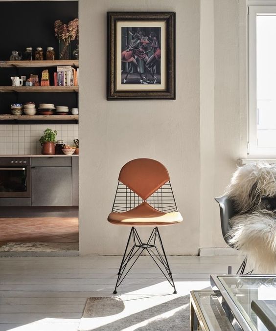 an Eames wire chair with leather seat pads looks more eye-catchy and is more comfortable to sit on, you may get some for indoors
