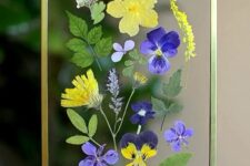 bold pansies and chamomiles plus leaves in a gilded frame with chain are amazing to style your space for summer