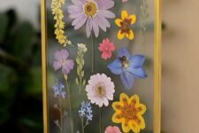 pressed colorful blooms in a gilded frame on chain is a cool and fun idea for summer, they will bring color to the space