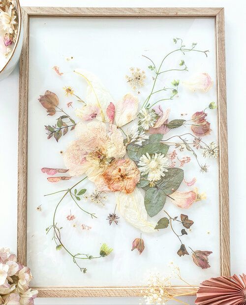 pressed neutral and pastel blooms and leaves in a light stained frame are a nice idea for a boho space