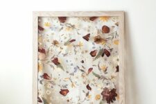 pressed neutral, mustard and burgundy blooms and leaves in a light-stained frame is a lovely decoration for the fall