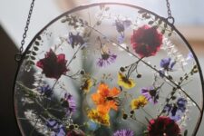 super bold pressed flowers in a round metal frame on chain can be hung both outdoors and indoors