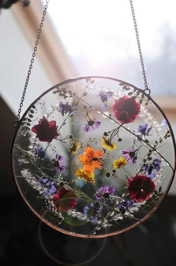 super bold pressed flowers in a round metal frame on chain can be hung both outdoors and indoors