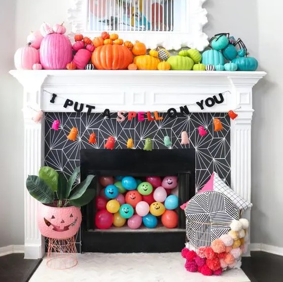 rainbow pumpkins, colorful balloons, bright tassle ghosts and a garland for Halloween