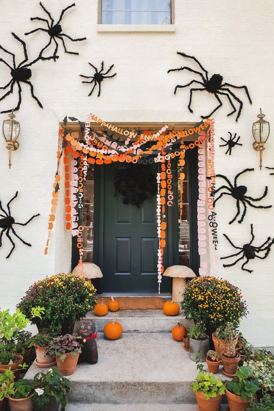 orange, black and white and pink paper Halloween banners with letters are a cool idea for a porch or a mantel