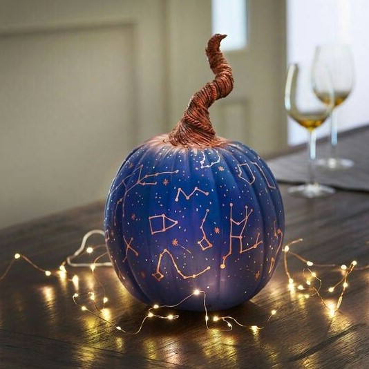 a bright blue Halloween pumpkin with gold constellations and a whimsical wrapped stem is a catchy and lovely idea