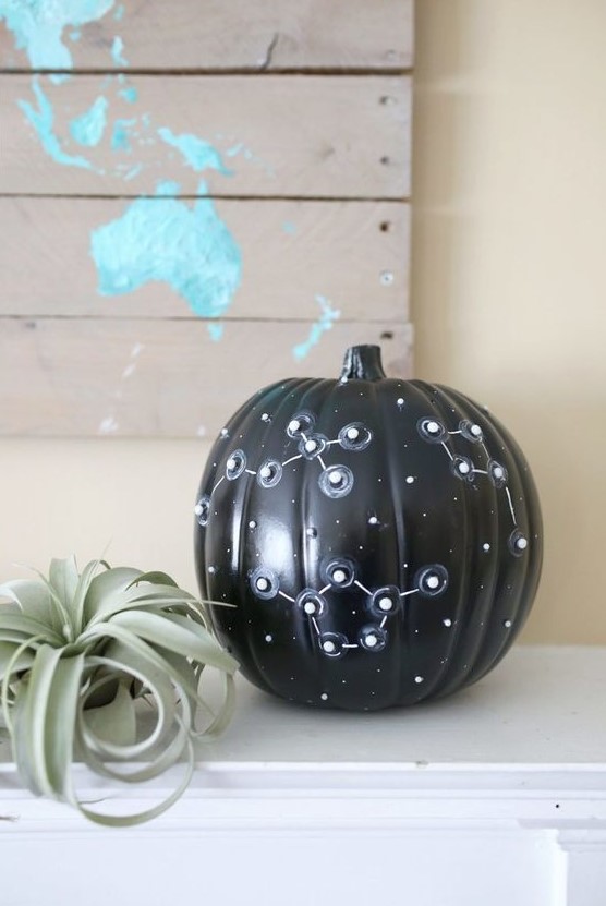 a catchy black Halloween pumpkin with white star spots and 3D constellations is a lovely idea and requires no carving