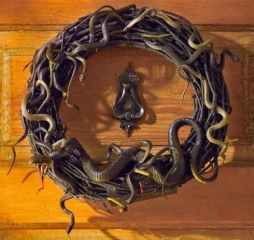 a black vine wreath with lots of snakes is a timeless front door decoration for Halloween
